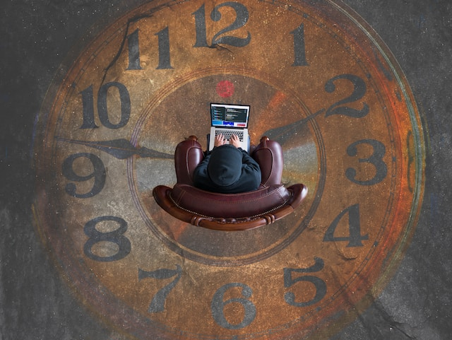 blog post; a va can save you time; person sitting in a chair typing on a laptop; surrounded by a clock; decorative